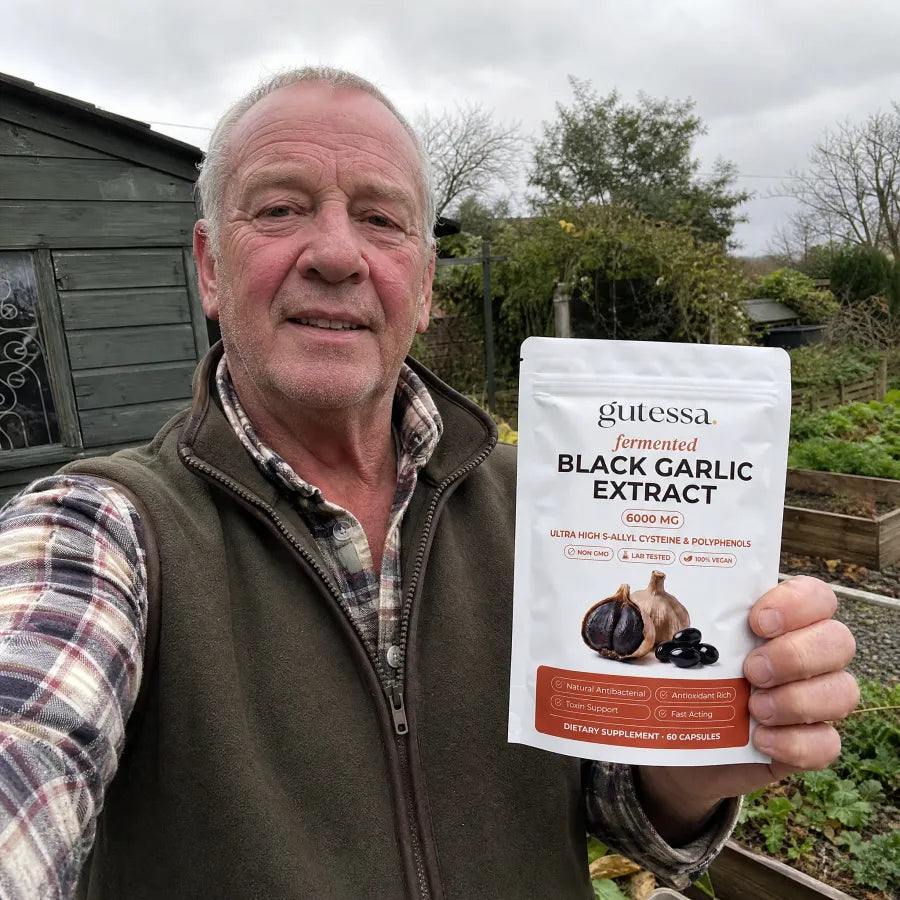 Stan holding his Gutessa pouch by the garden shed