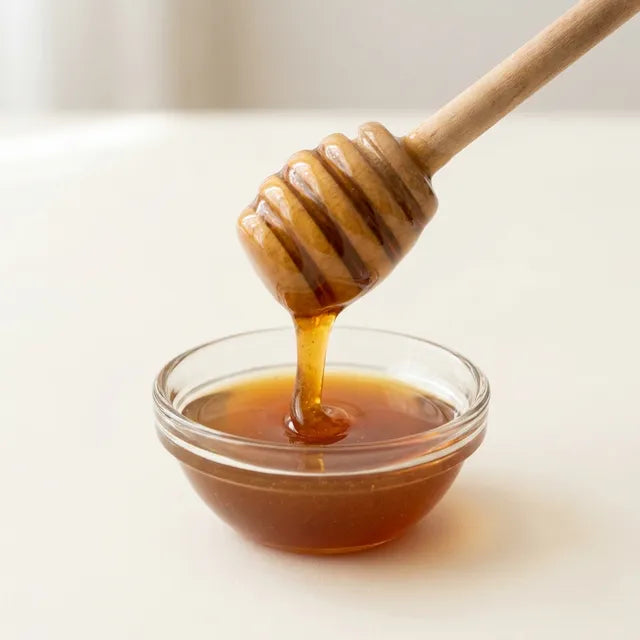 Organic manuka honey on a wooden dipper