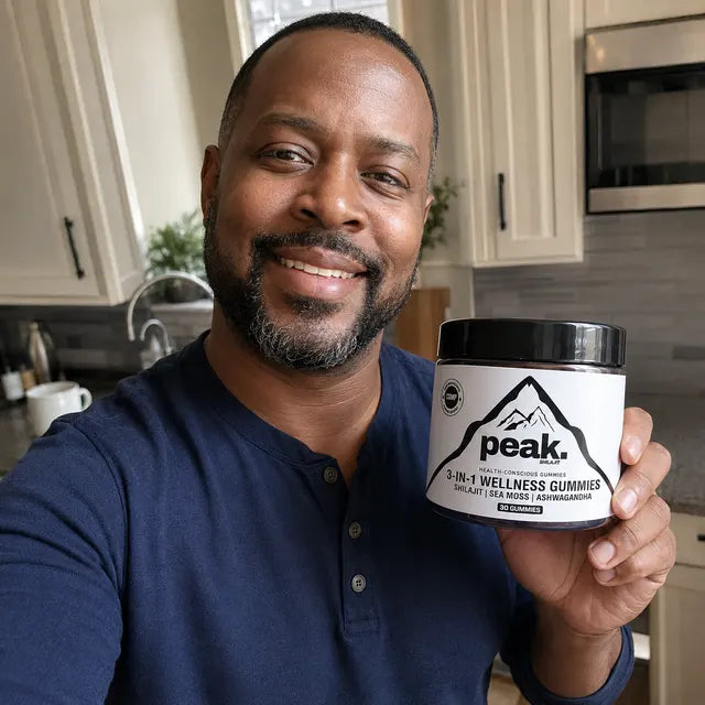 Customer holding a jar of Peak 3-in-1 Wellness Gummies in his kitchen